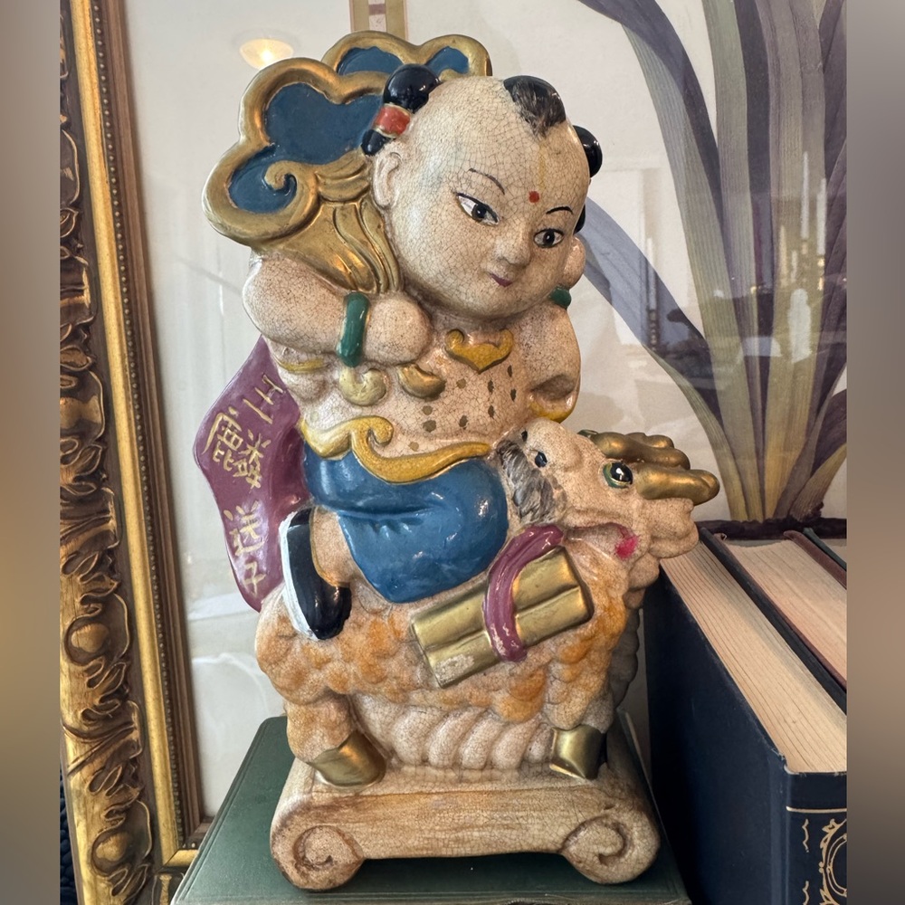 Chinese ceramic figure depicting a child warrior riding a dragon